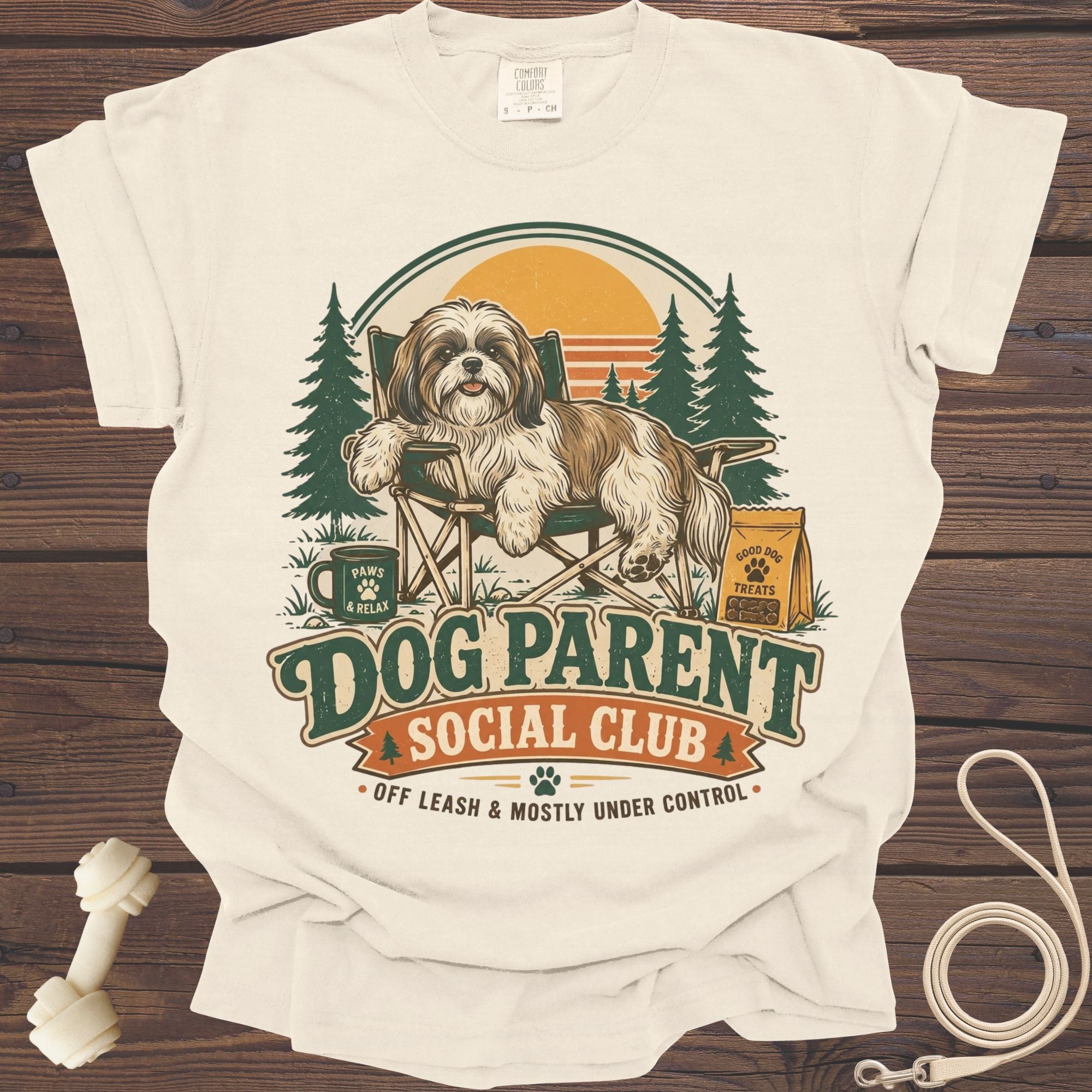 Shih Tzu on camping chair with "Dog Parent Social Club" text and dog accessories.