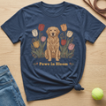 Navy t-shirt with golden retriever and tulips graphic, text "Paws in Bloom".