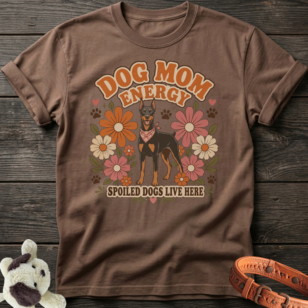 Brown t-shirt with Doberman, flowers, and text "Dog Mom Energy Spoiled Dogs Live Here."