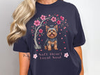 Yorkshire Terrier under a cherry blossom tree with text "Soft Heart Loyal Soul".