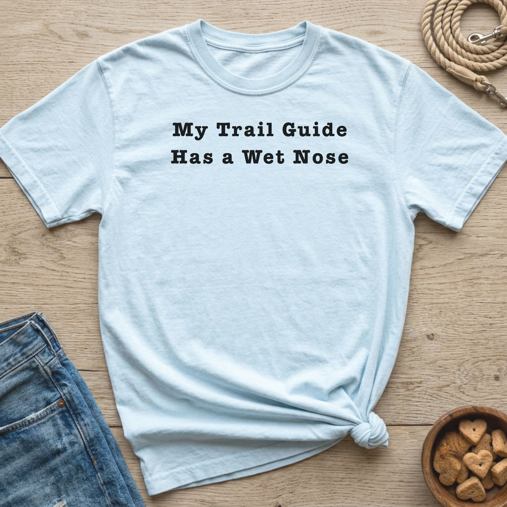 Light blue t-shirt with black text "My Trail Guide Has a Wet Nose".