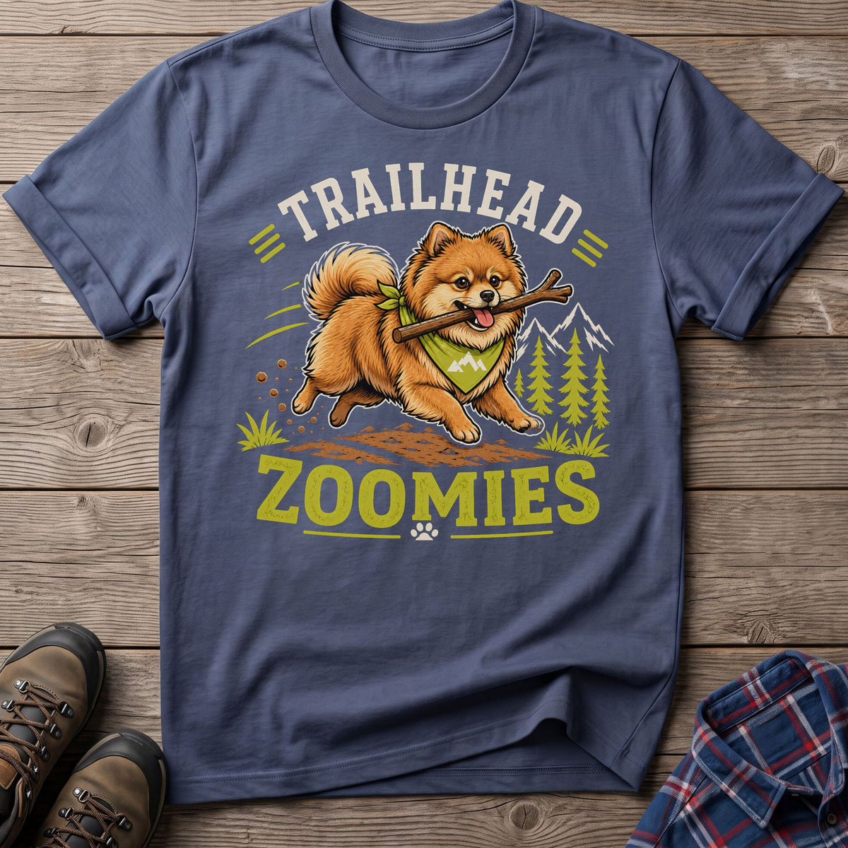 T-shirt graphic of a Pomeranian dog with a stick and the text "TRAILHEAD ZOOMIES".