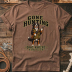 Bernese mountain dog wearing hunting vest holding rifle, text reads "Gone Hunting Dog House Hunt Club".