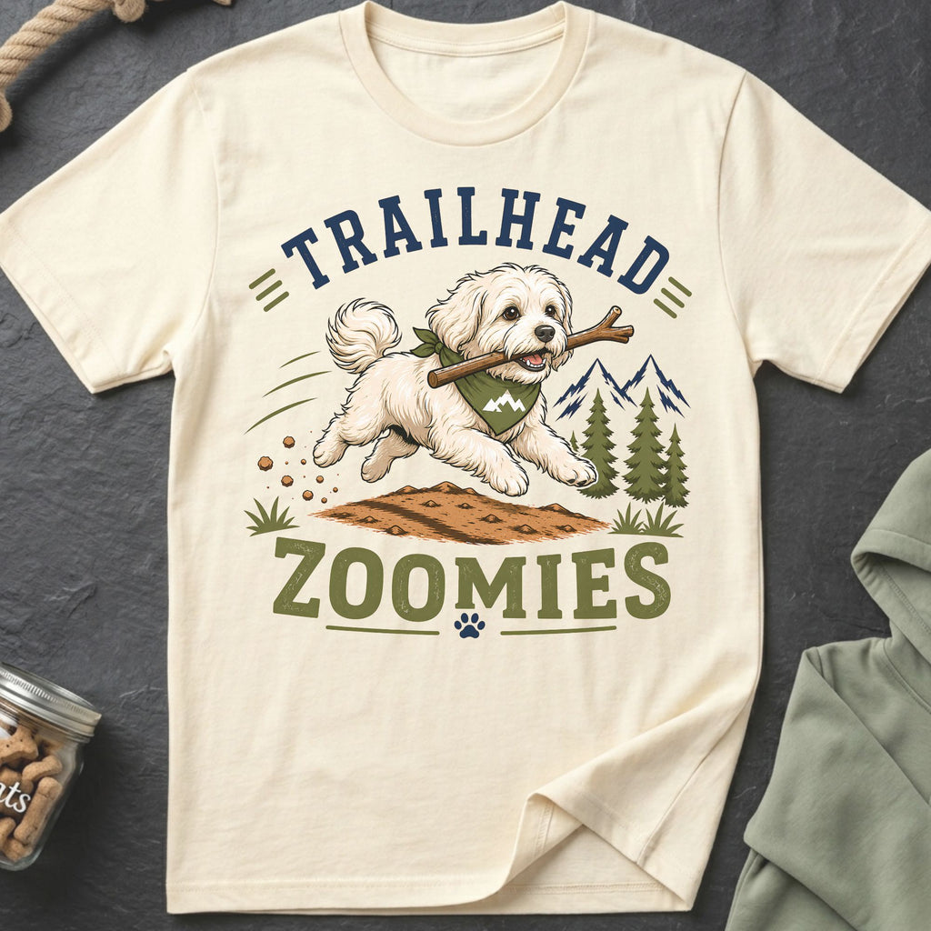Cream t-shirt with white dog running with stick, text "TRAILHEAD ZOOMIES".