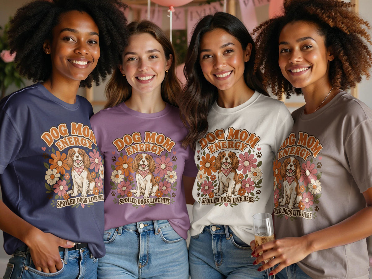 Four women wear t-shirts with "Dog Mom Energy" graphic featuring a dog and flowers.