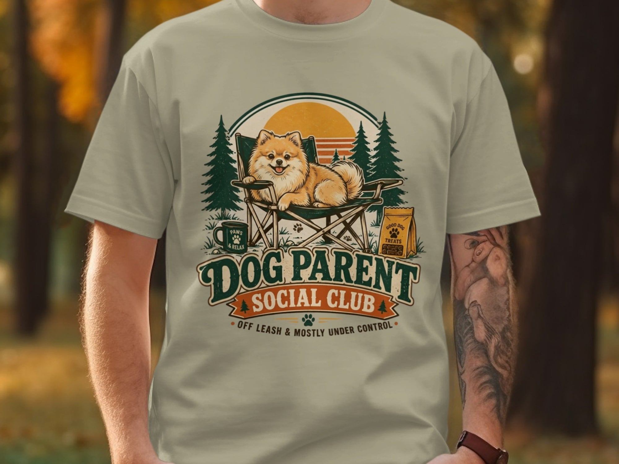 Pomeranian dog in camping chair with "Dog Parent Social Club" text and treats.