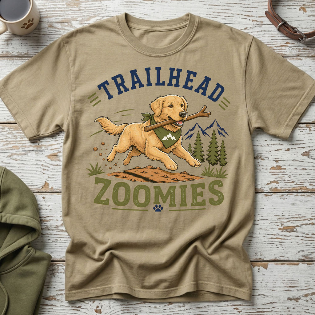 Golden retriever running with stick on shirt with text "TRAILHEAD ZOOMIES."