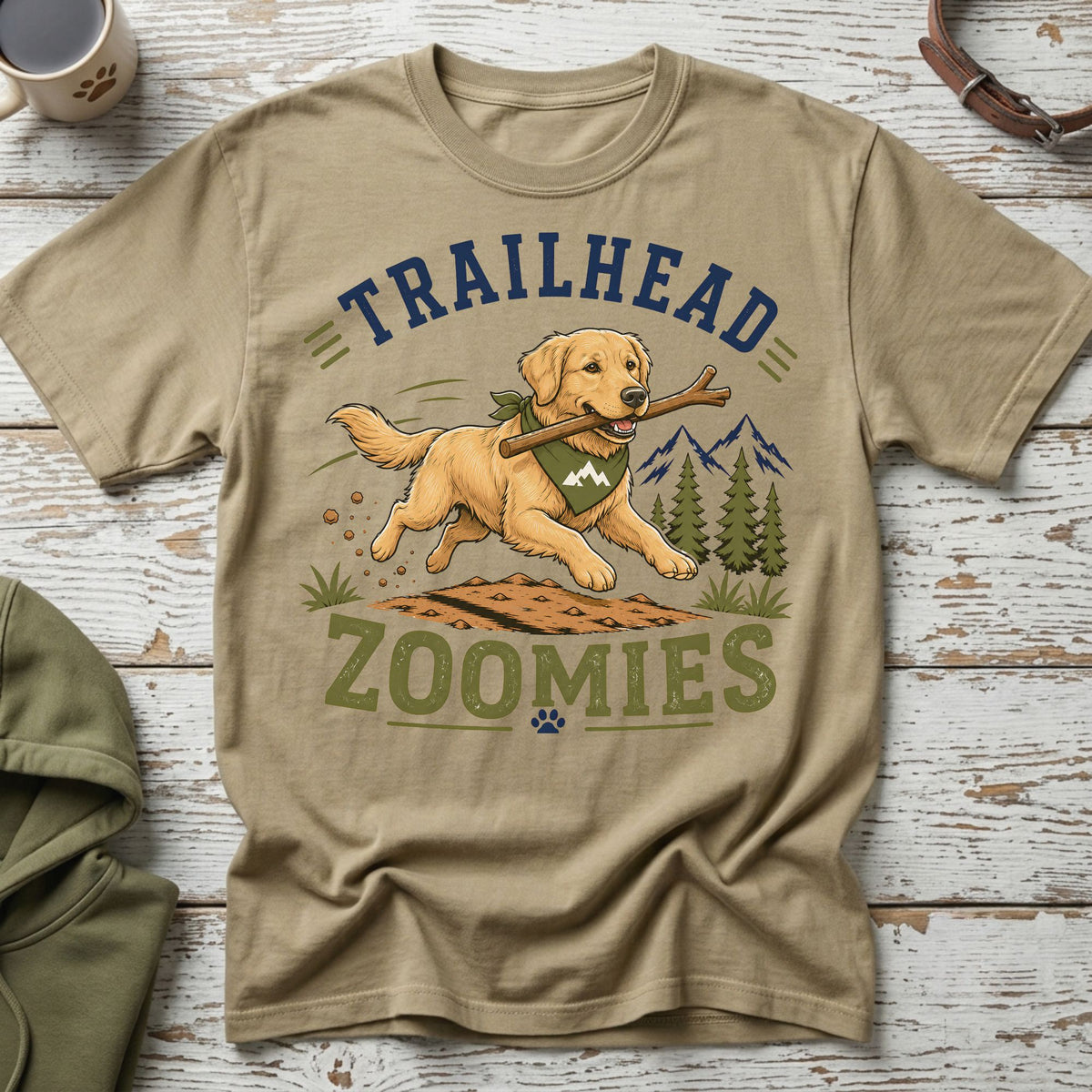 Golden retriever running with stick on shirt with text "TRAILHEAD ZOOMIES."