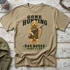Tan t-shirt with a dog holding a shotgun and text "Gone Hunting Dog House Hunt Club".
