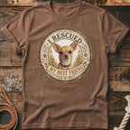 Brown t-shirt with a round graphic of a Chihuahua wearing a collar, text "I RESCUED" and "MY BEST FRIEND".