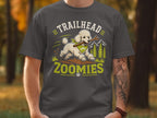 White poodle with bandana runs with stick, text "TRAILHEAD ZOOMIES"
