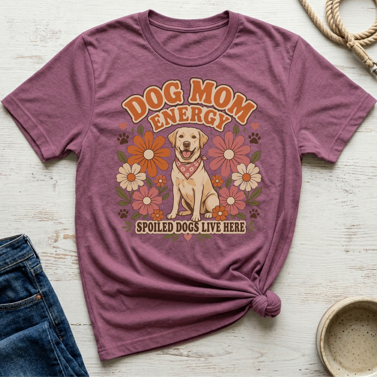 Purple t-shirt with "Dog Mom Energy" and "Spoiled Dogs Live Here" text, featuring a dog and flowers.