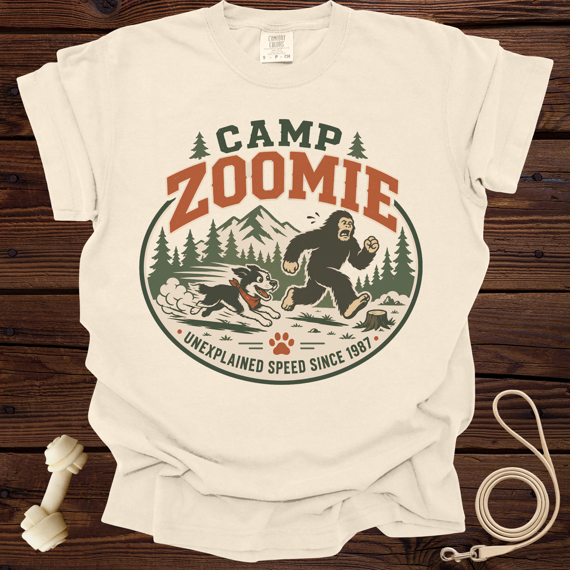 Camp Zoomie Bigfoot and dog chase graphic with text "Unexplained Speed Since 1987".