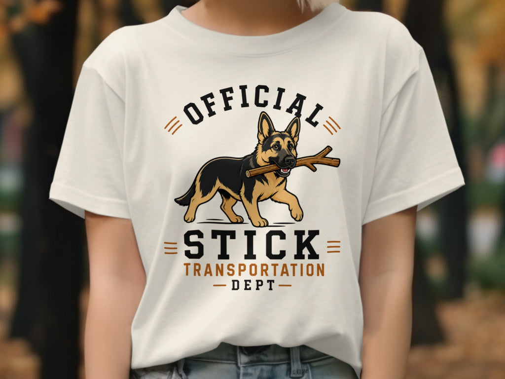 German Shepherd with stick on shirt that reads "Official Stick Transportation Dept."