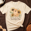 Cream t-shirt with fluffy dog and sunflowers graphic that reads "You Are My Sunshine Pup."