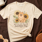 Cream t-shirt with fluffy dog and sunflowers graphic that reads "You Are My Sunshine Pup."
