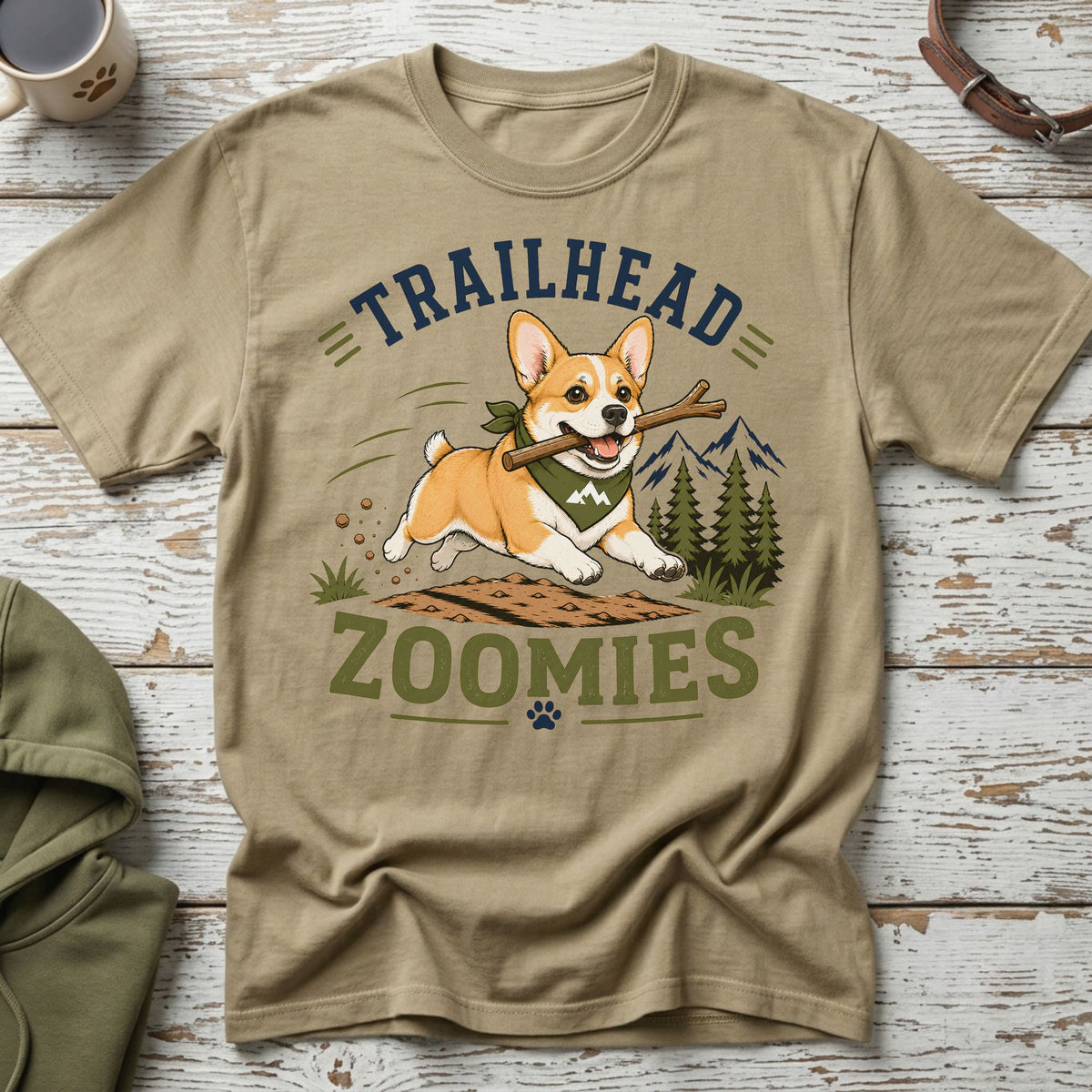 Tan t-shirt with a corgi running with a stick, text "TRAILHEAD ZOOMIES".