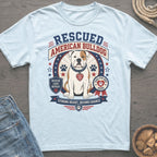 Light blue t-shirt featuring a graphic of a rescued American Bulldog with patriotic stars and stripes.