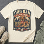 Cream t-shirt with "Dog Dad Department" graphic, featuring a dachshund, toolbox, and dog essentials.