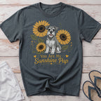 Schnauzer dog sitting among sunflowers with text "You Are My Sunshine Pup".