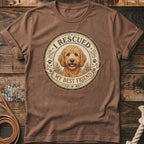 Brown t-shirt with a circular graphic featuring a Goldendoodle dog and text "I Rescued My Best Friend".