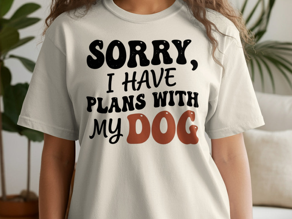 Cream t-shirt with black text saying "SORRY, I HAVE PLANS WITH MY DOG".