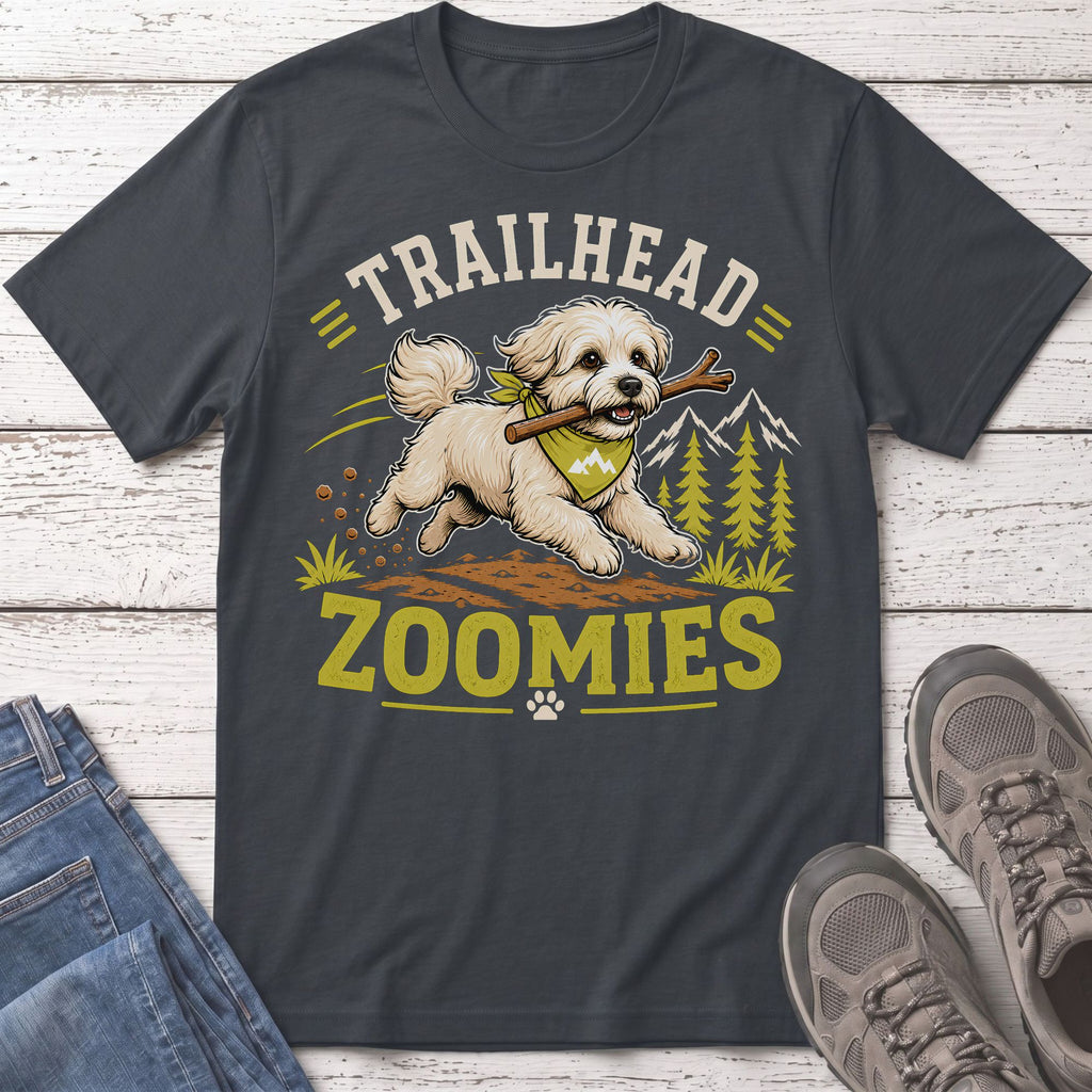 Fluffy dog with stick and bandana, "Trailhead Zoomies" text on a dark gray t-shirt.