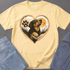 Yellow t-shirt with heart design featuring a dog, paw print, and sunset.