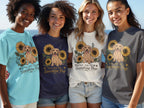 Four women model t-shirts featuring a dachshund and sunflowers with text "You Are My Sunshine Pup."