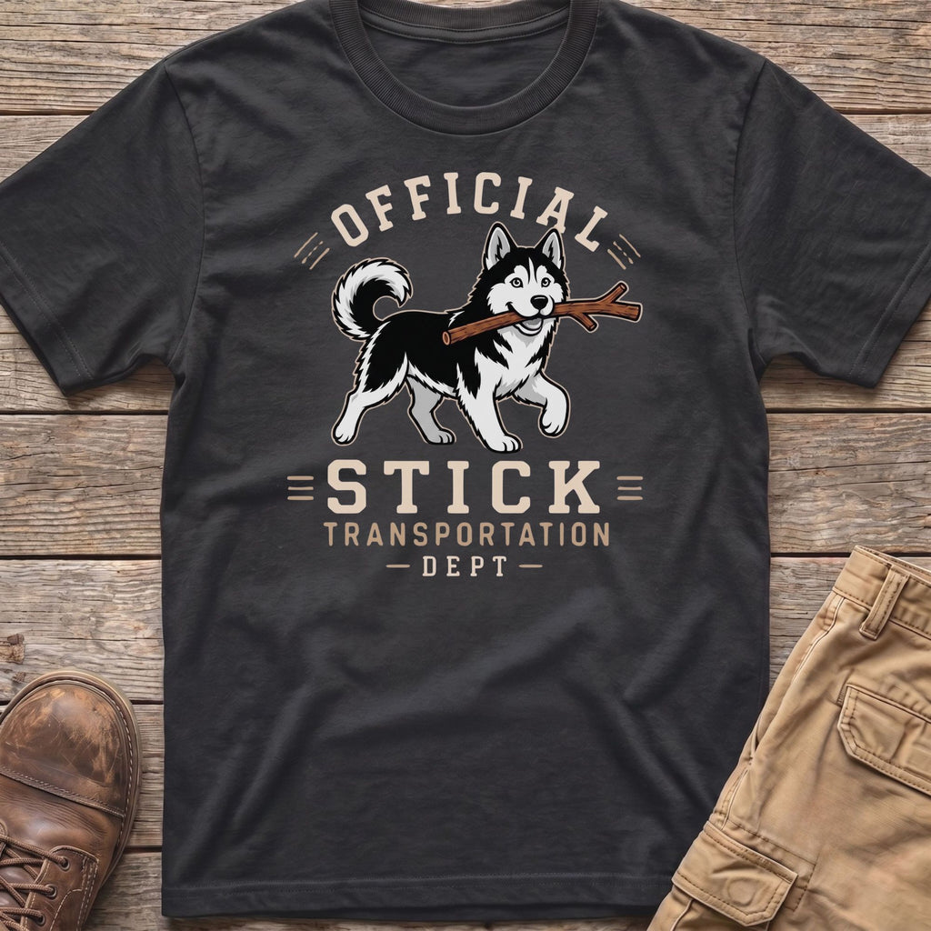 Husky dog with stick on t-shirt reading "Official Stick Transportation Dept."