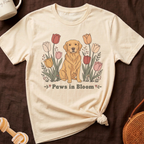 Golden retriever in front of tulips with text "Paws in Bloom".