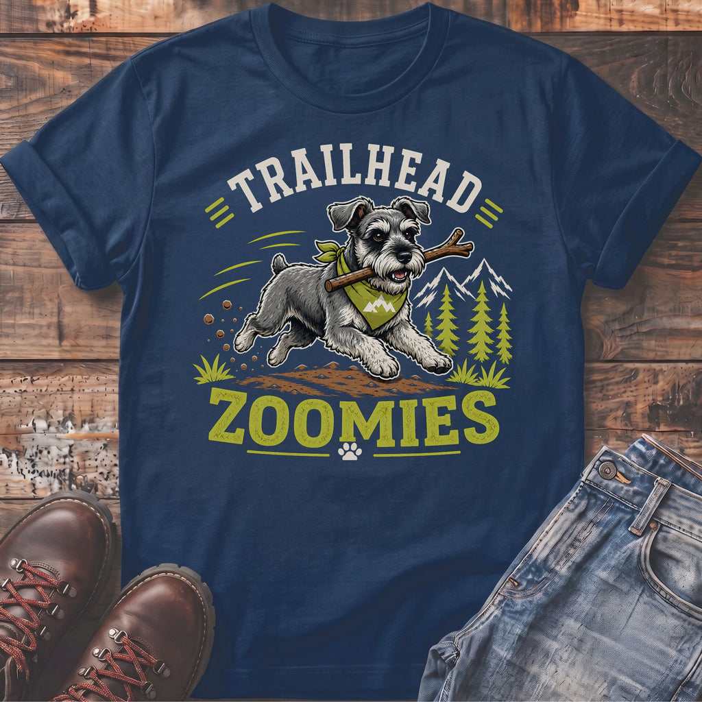 Schnauzer dog with stick on shirt saying "Trailhead Zoomies"