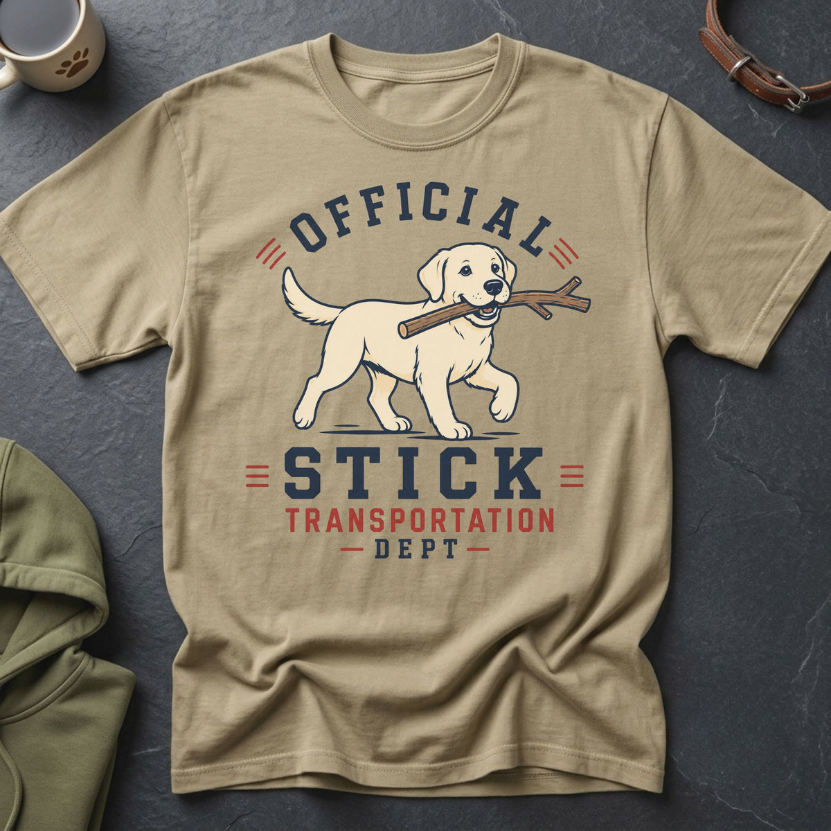 Tan t-shirt with a Labrador carrying a stick and text that reads "Official Stick Transportation Dept".