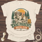 T-shirt graphic with a Shih Tzu dog on a camping chair. Text reads "Dog Parent Social Club".