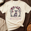 Cream t-shirt with a schnauzer sitting under a floral arch with the text "Soft Heart Loyal Soul."