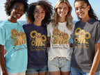 Four women wear t-shirts featuring a golden retriever and sunflowers with "You Are My Sunshine Pup" text.