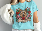 Yorkshire terrier surrounded by roses, with banner text "Loyal Love Blooms".