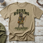 Tan t-shirt with a dog holding a shotgun, saying "Gone Hunting Dog House Hunt Club".