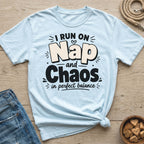 Light blue t-shirt with "I RUN ON Nap and Chaos in perfect balance" graphic.