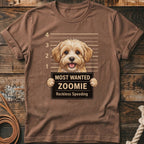 Brown t-shirt graphic of a fluffy dog holding a "Most Wanted Zoomie" sign.