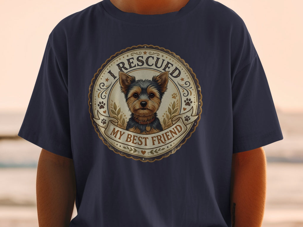 Dark blue t-shirt with a circular emblem featuring a Yorkshire Terrier and text "I RESCUED MY BEST FRIEND."