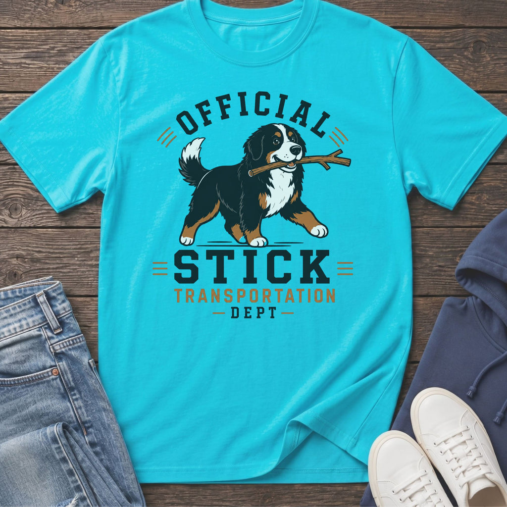 Bernese Mountain Dog with stick on turquoise t-shirt reading "Official Stick Transportation Dept".