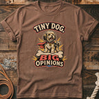 Brown t-shirt with a small dog wearing a cape and sitting on a bone with text.