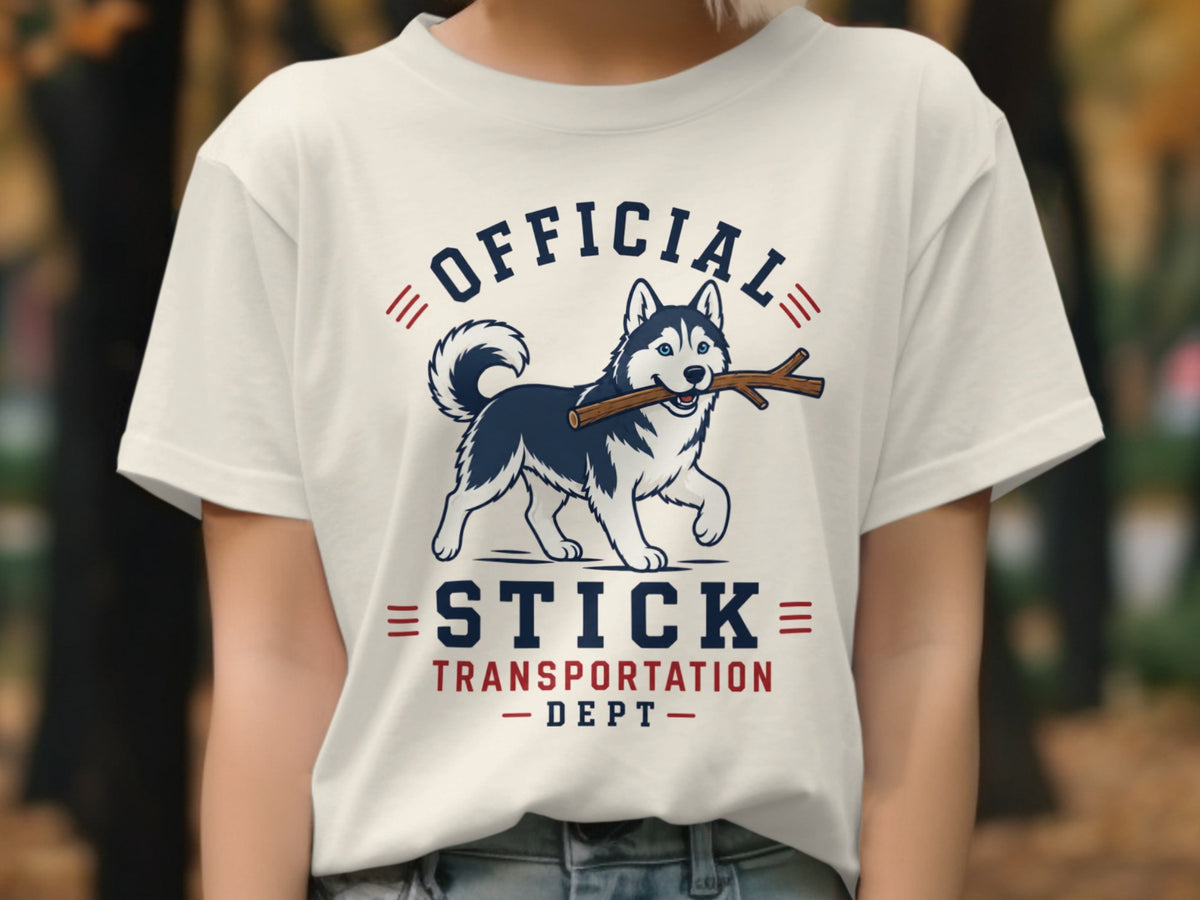 White t-shirt with husky holding stick and text "OFFICIAL STICK TRANSPORTATION DEPT".
