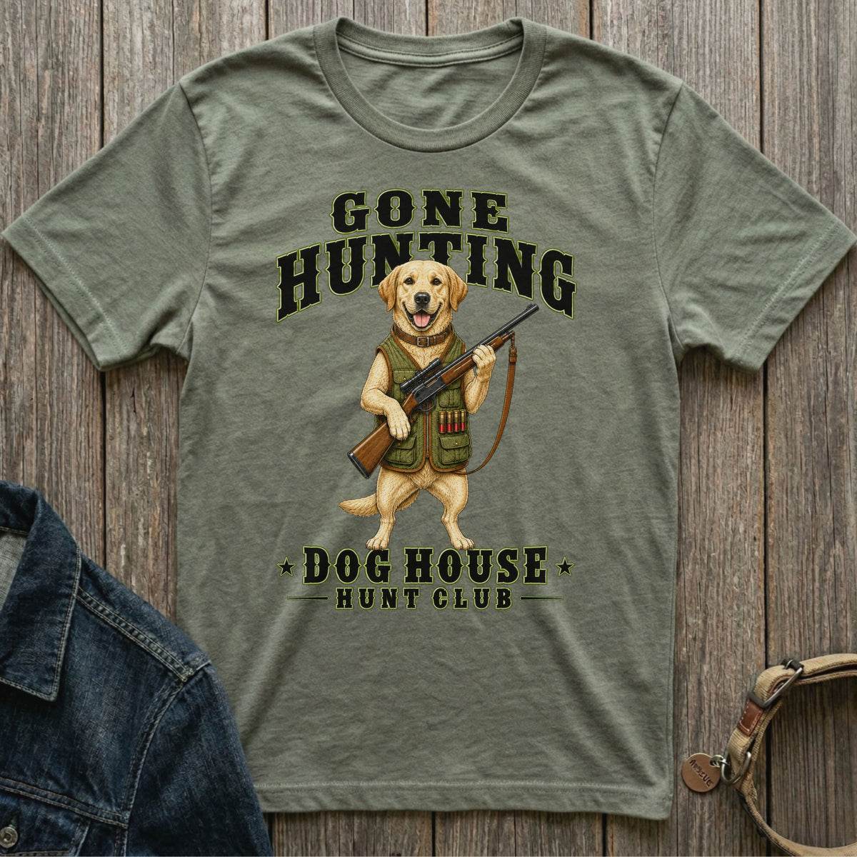 Green t-shirt with graphic of a dog holding a rifle, "Gone Hunting Dog House Hunt Club" text.