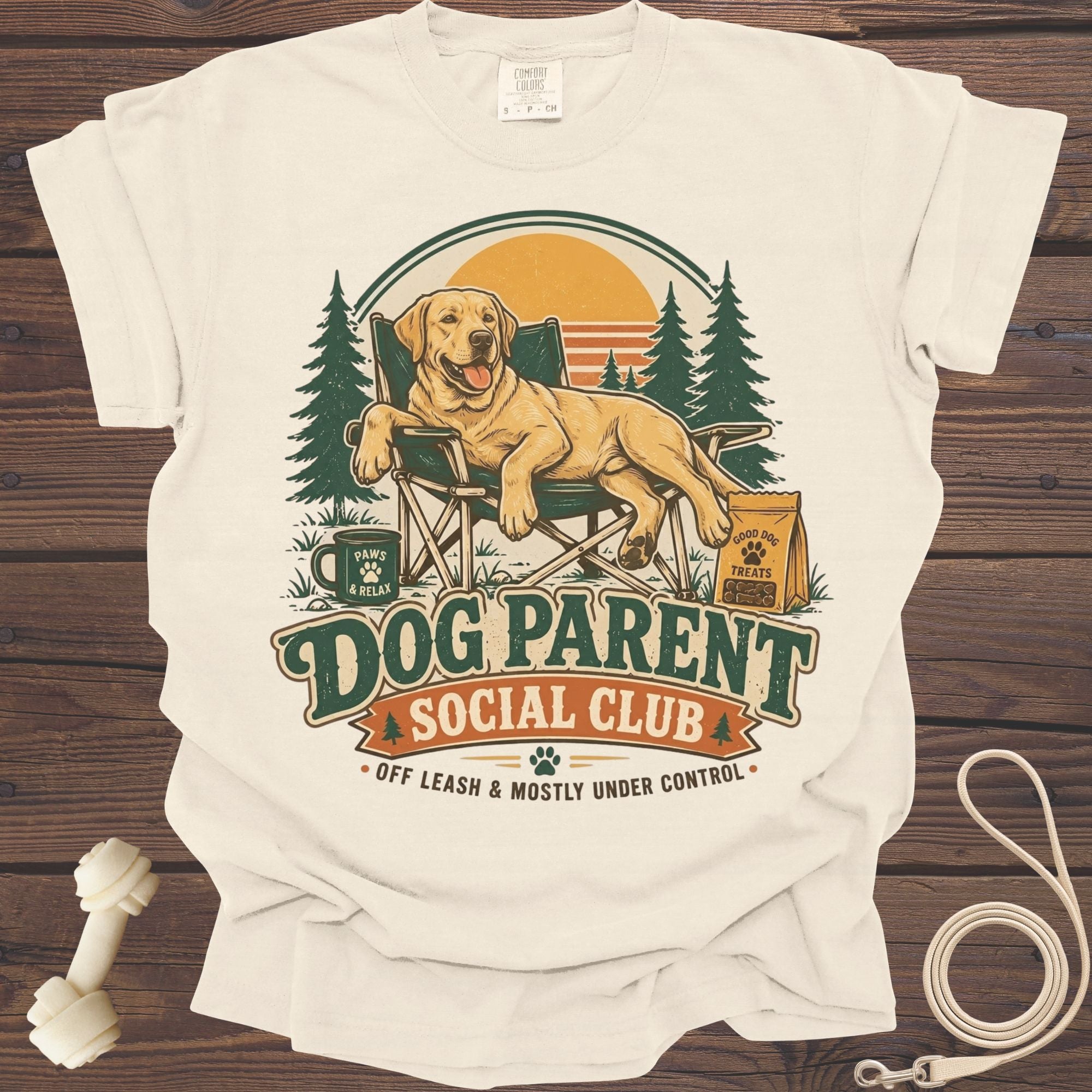 Cream t-shirt with "Dog Parent Social Club" graphic featuring a happy dog in a chair.
