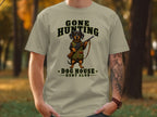 T-shirt graphic of a dachshund in hunting gear holding a rifle.