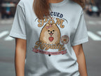 Light blue t-shirt with a Pomeranian wearing a bow, reading "Rescued Pom Royalty".