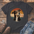 Dark t-shirt with a distressed dog portrait and heart graphic on a sunset background.