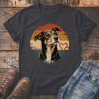 Dark t-shirt with a distressed dog portrait and heart graphic on a sunset background.